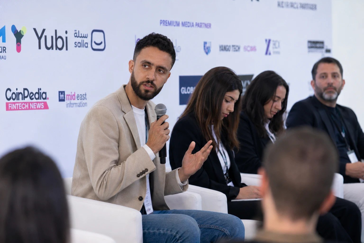Mohamed Arfaoui speaking into a microphone during a panel discussion